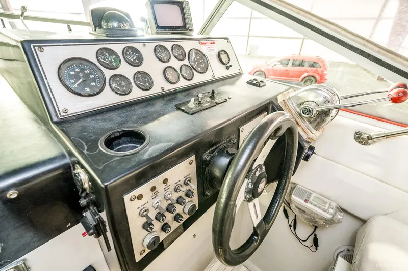 Slide: The Image of 1987 Chris-Craft 320 Amerosport Express boat helm with gauges and controls. - 28