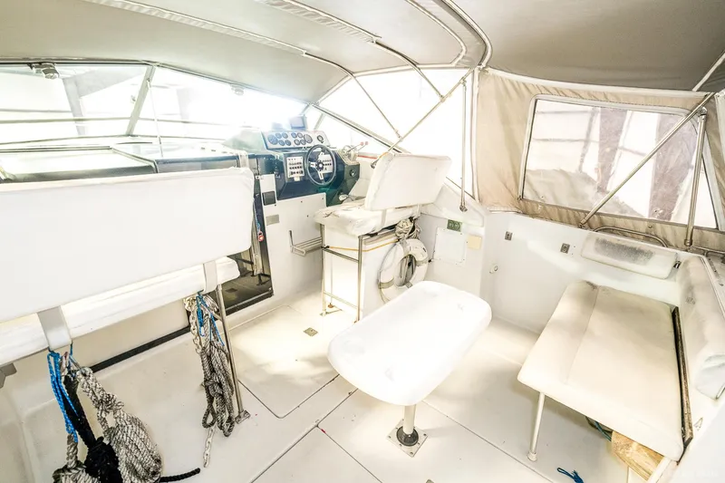 Slide: The Image of 1987 Chris-Craft 320 Amerosport Express boat interior with helm, seating, and storage. - 30