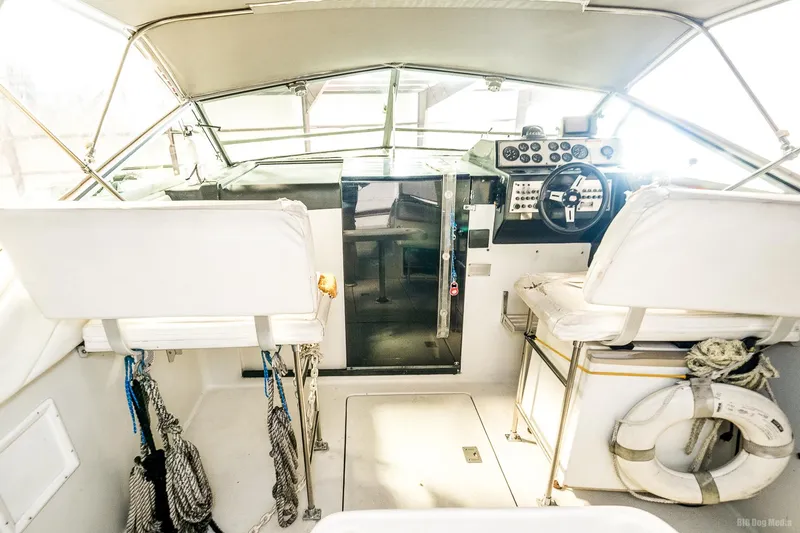 Slide: The Image of 1987 Chris-Craft 320 Amerosport Express boat cockpit with steering wheel and seating. - 31