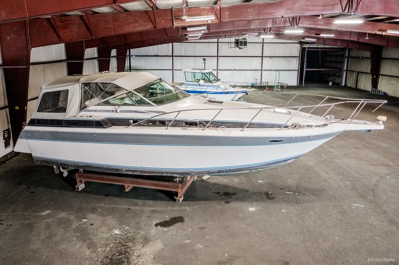 Slide: The Image of 1987 Chris-Craft 320 Amerosport Express boat in indoor storage facility. - 6