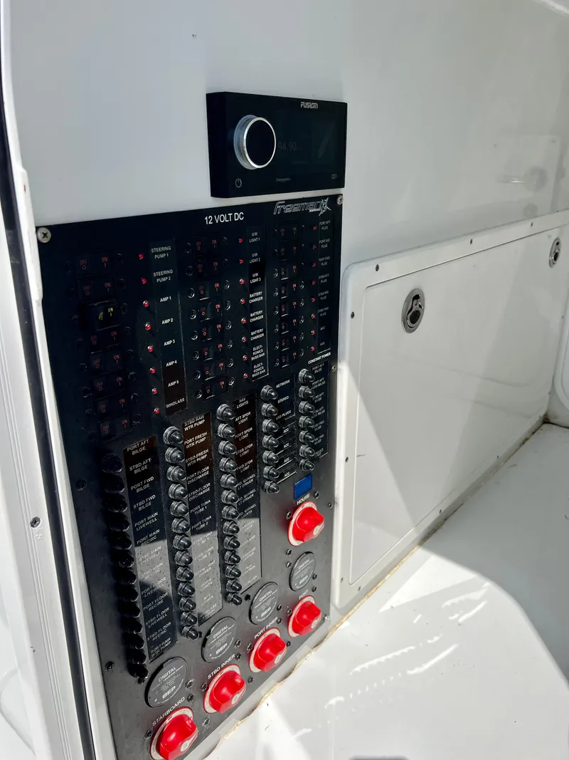Slide: The Image of Control panel of a 2021 Freeman 37VH boat, featuring switches and gauges. - 11