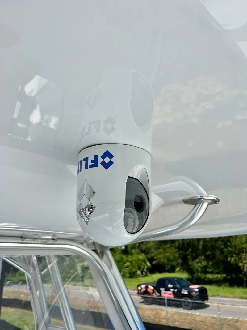 Slide: The Image of FLIR camera mounted on a Freeman 37VH boat, 2021 model, with a road in the background. - 20