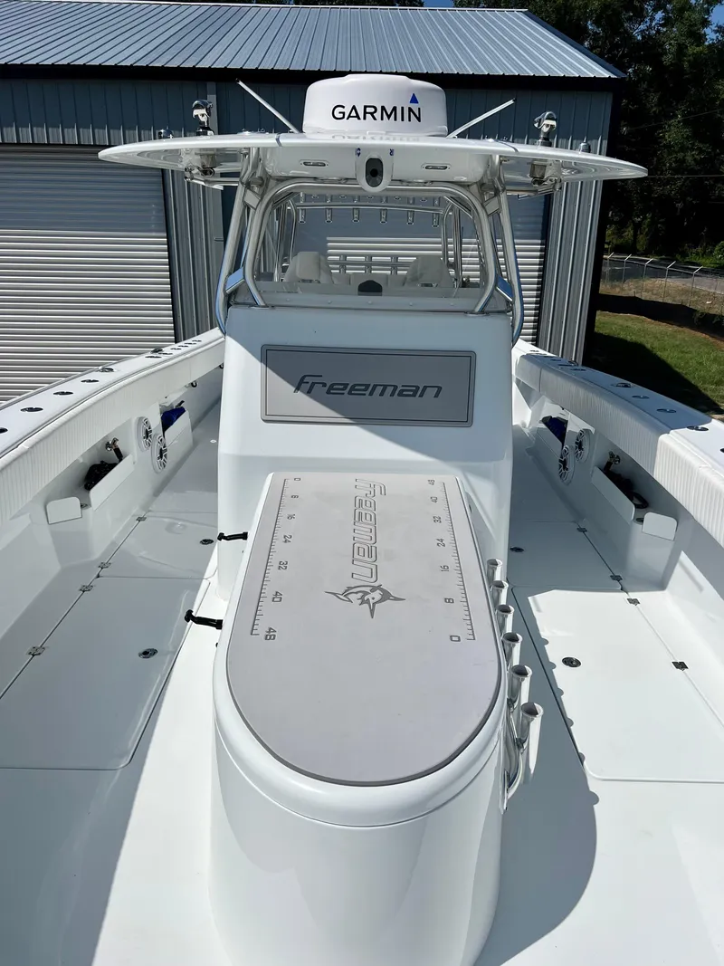 Slide: The Image of 2021 Freeman 37VH boat with Garmin equipment, featuring spacious deck and modern design. - 22