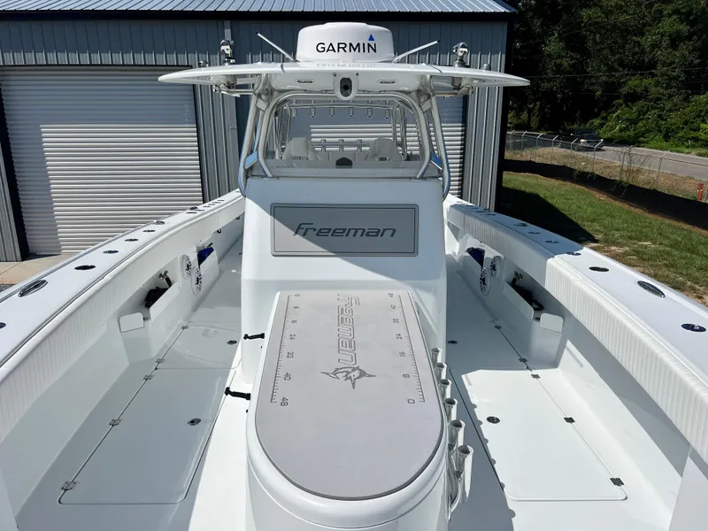 Slide: The Image of Freeman 37VH 2021 boat with Garmin equipment, docked near a storage facility. - 23