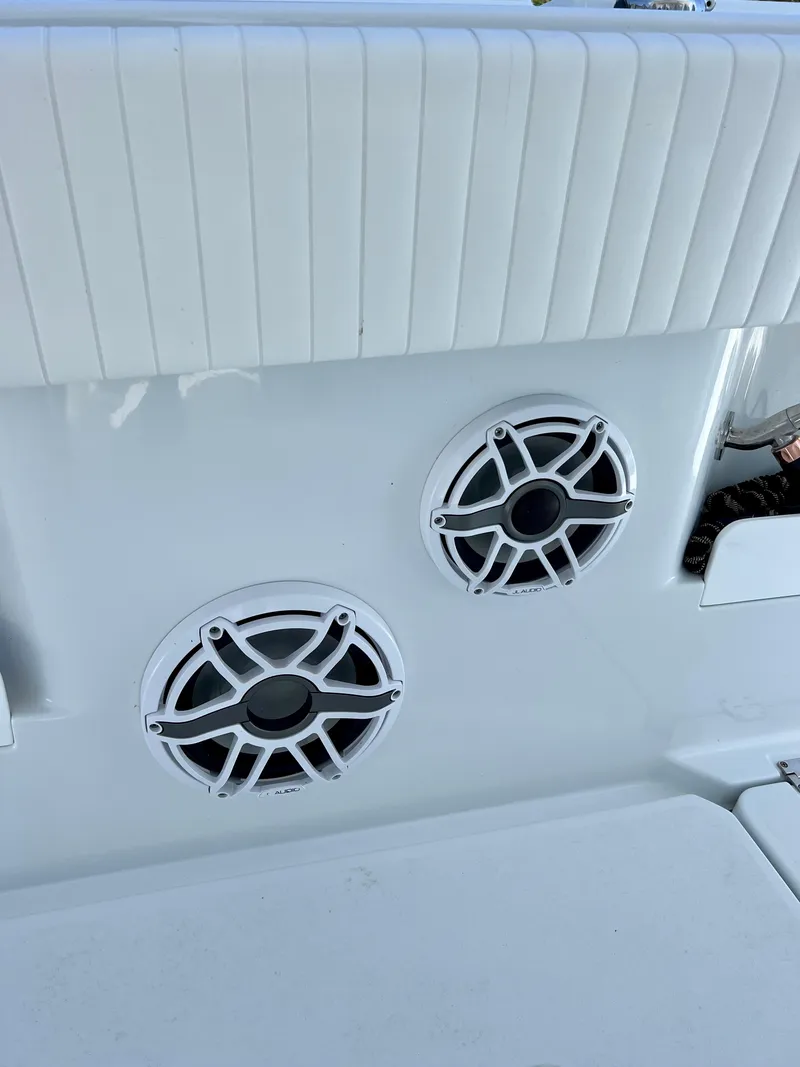 Slide: The Image of Freeman 37VH 2021 boat interior with dual speakers and white upholstery. - 25