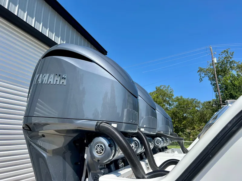Slide: The Image of Triple Yamaha outboard motors on a Freeman 37VH boat, 2021 model, under clear blue sky. - 5