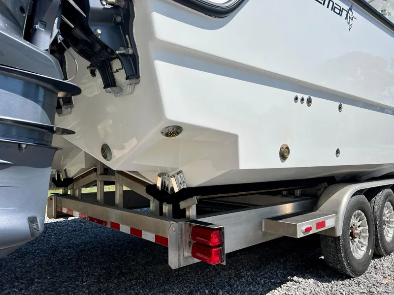 Slide: The Image of Freeman 37VH 2021 boat on trailer, rear view, showcasing hull and outboard motor. - 8