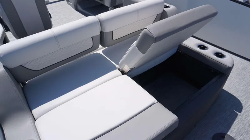 Slide: The Image of 2024 MONACO 235 DFL boat interior with adjustable seating and cup holders. - 11