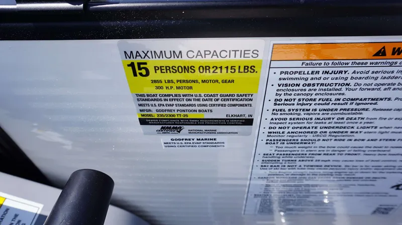 Slide: The Image of 2024 MONACO 235 DFL boat capacity label, 15 persons or 2115 lbs, 300 HP motor. - 12