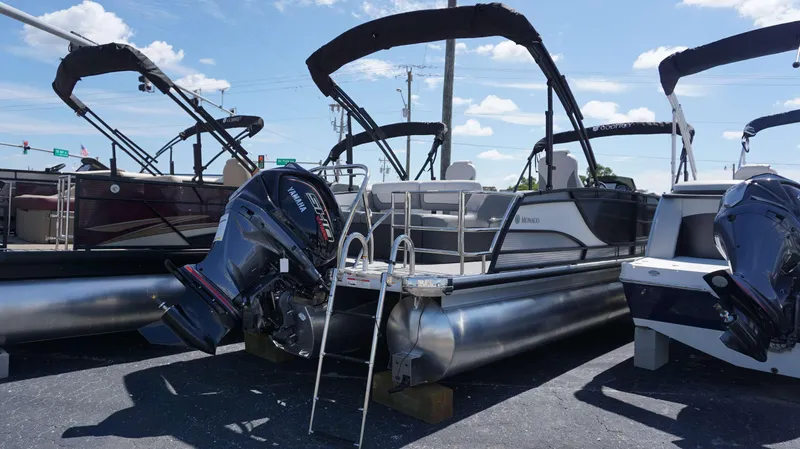 Slide: The Image of 2024 MONACO 235 DFL pontoon boat with Yamaha outboard motor in a dealership lot. - 13