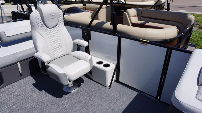 Slide: The Image of 2024 MONACO 235 DFL boat interior with luxurious seating and cup holders. - 18