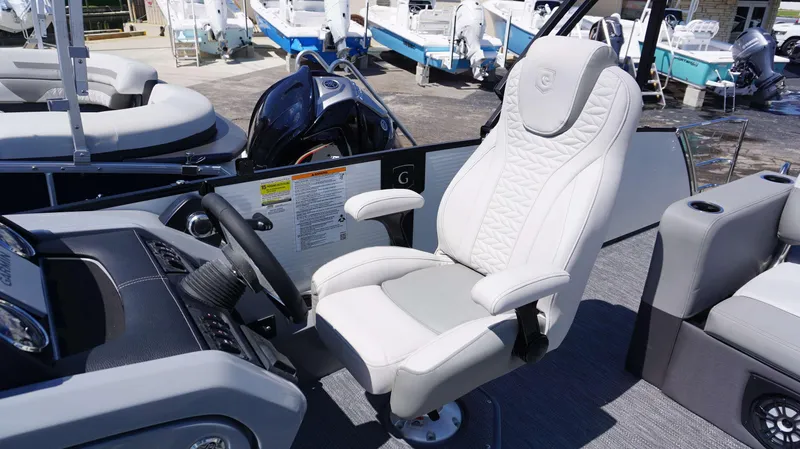 Slide: The Image of Captain's chair and helm of 2024 MONACO 235 DFL boat, with luxurious seating and modern controls. - 19