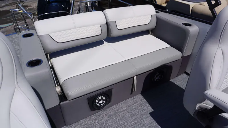 Slide: The Image of 2024 MONACO 235 DFL boat interior with gray and white cushioned seating and built-in speakers. - 20