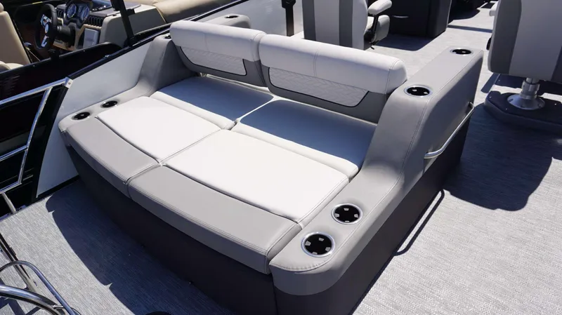 Slide: The Image of 2024 MONACO 235 DFL boat interior with cushioned seating and cup holders. - 4