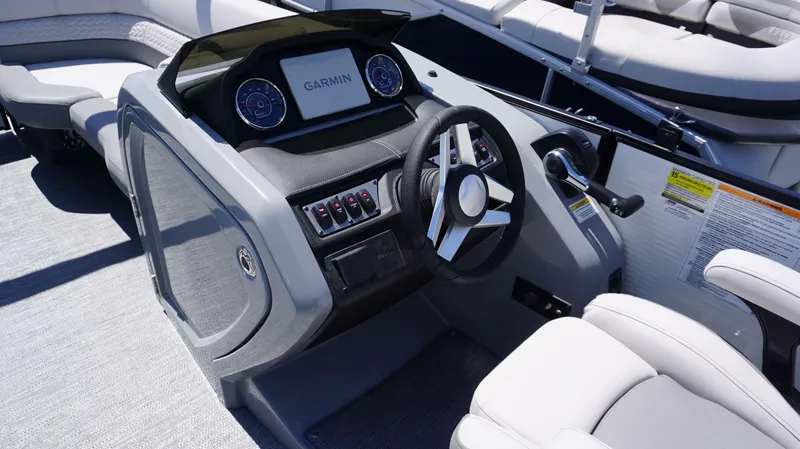 Slide: The Image of 2024 MONACO 235 DFL boat dashboard with Garmin navigation system and steering wheel. - 7