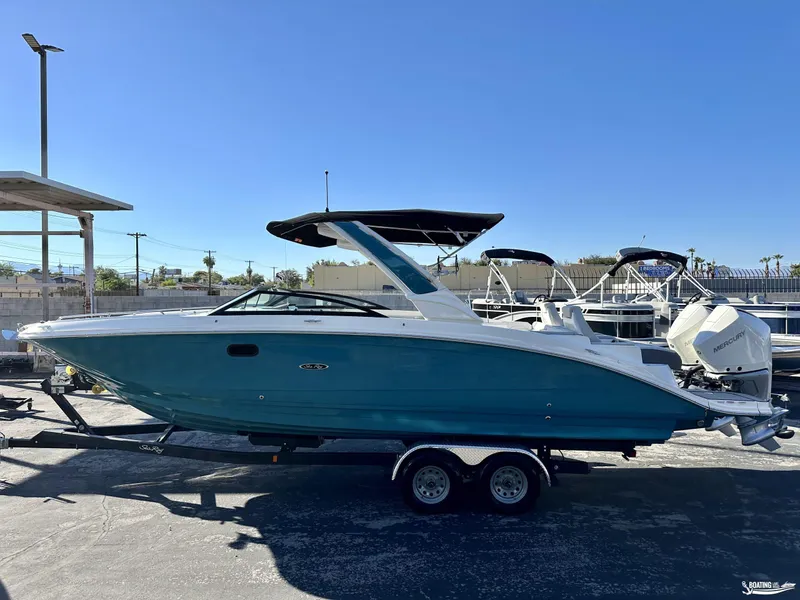 Slide: The Image of 2024 Sea Ray SDX 290 OB boat on trailer, blue hull, outdoor display. - 0