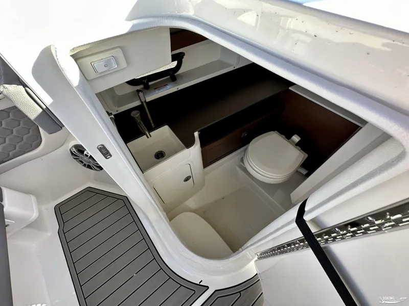 Slide: The Image of 2024 Sea Ray SDX 290 OB boat interior with compact bathroom and sink. - 11