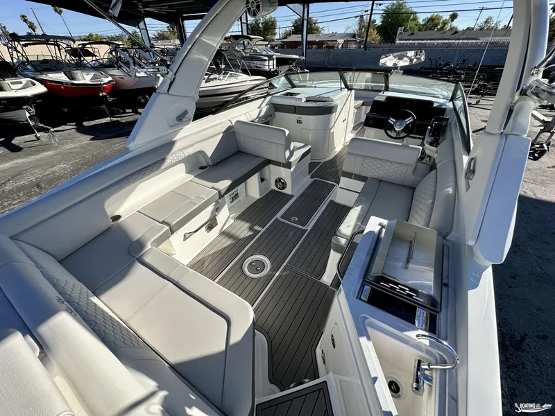 Slide: The Image of 2024 Sea Ray SDX 290 OB boat interior with luxurious seating and modern amenities. - 13
