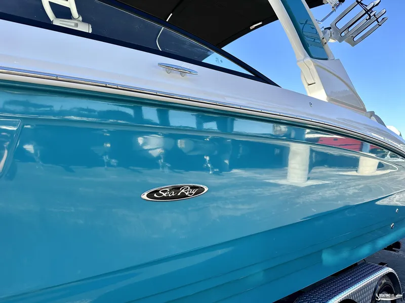 Slide: The Image of 2024 Sea Ray SDX 290 OB boat, blue hull, side view. - 2
