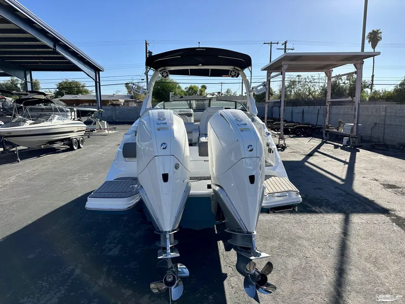 Slide: The Image of 2024 Sea Ray SDX 290 OB boat with dual outboard engines in a marina. - 3