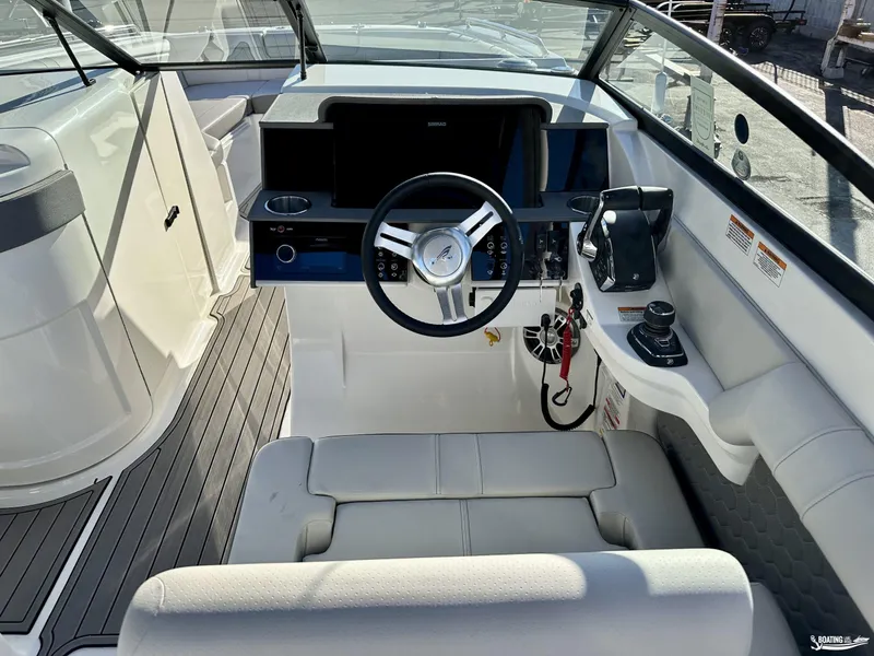 Slide: The Image of 2024 Sea Ray SDX 290 OB boat cockpit with modern steering and controls. - 9