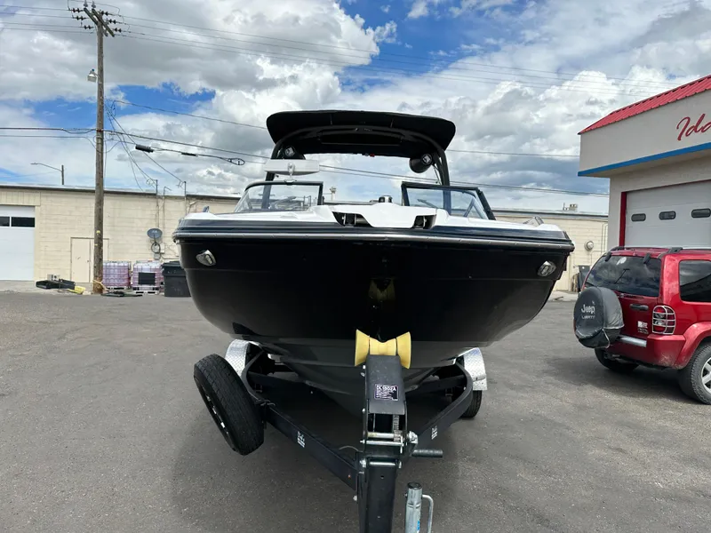 Slide: The Image of 2020 Yamaha 212X jet boat on trailer, parked outdoors under cloudy sky. - 10