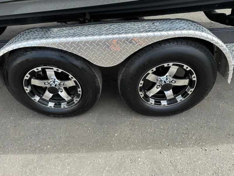 Slide: The Image of Trailer wheels of a 2020 Yamaha 212X jet boat with diamond plate fender. - 22