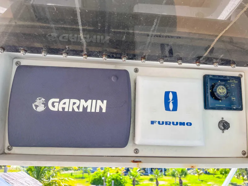 Slide: The Image of Garmin and Furuno navigation equipment on a 2000 Luhrs 400 Convertible boat. - 16