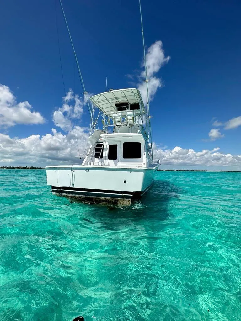 Slide: The Image of 2000 Luhrs 400 Convertible boat on clear turquoise water under a blue sky. - 2