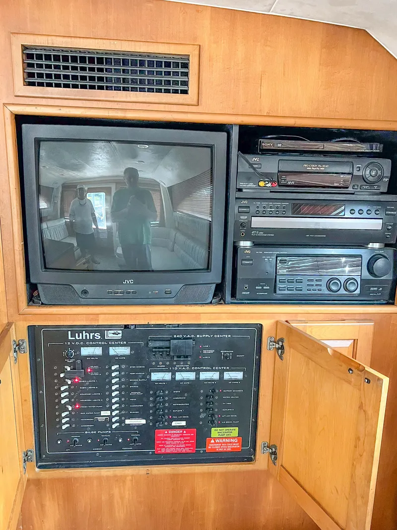 Slide: The Image of 2000 Luhrs 400 Convertible entertainment system with TV and control panel. - 22
