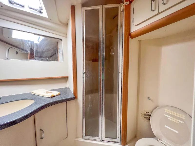 Slide: The Image of 2000 Luhrs 400 Convertible yacht bathroom with shower, sink, and toilet. - 27