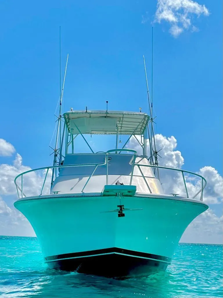 Slide: The Image of 2000 Luhrs 400 Convertible boat on clear blue water. - 3