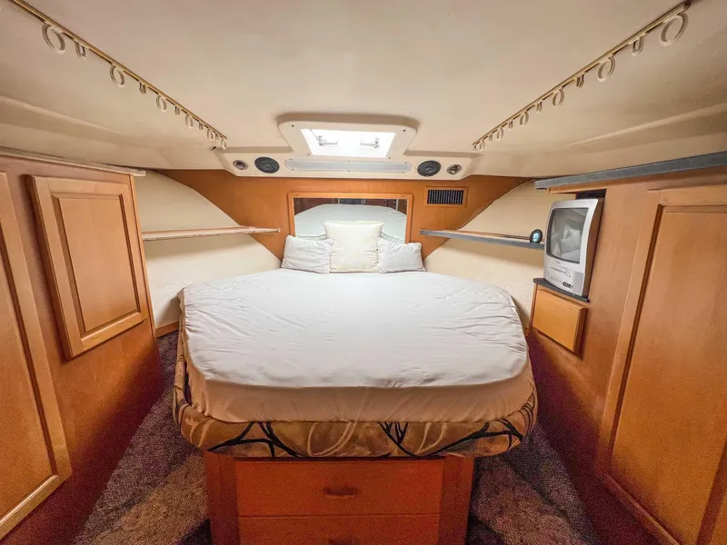 Slide: The Image of 2000 Luhrs 400 Convertible boat cabin with bed and TV - 30
