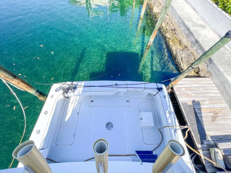 Slide: The Image of 2000 Luhrs 400 Convertible boat docked at a clear water marina. - 8