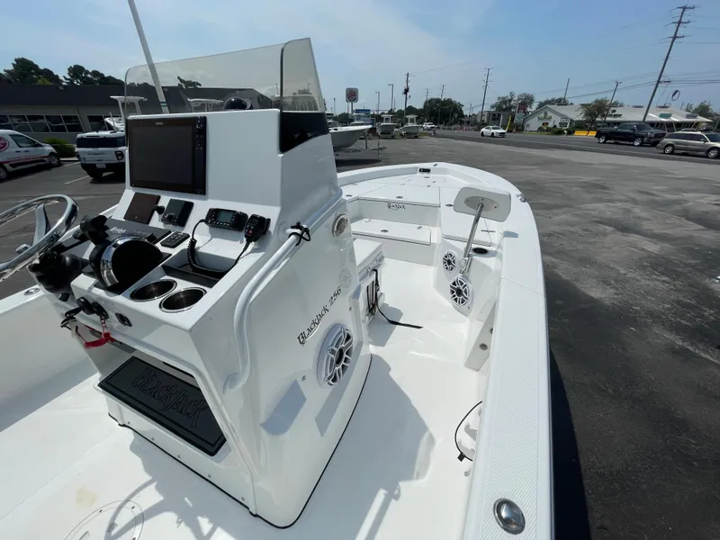 Slide: The Image of 2023 BlackJack 256 Bay boat with advanced navigation console in a parking lot. - 12