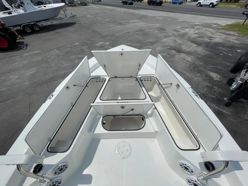 Slide: The Image of 2023 BlackJack 256 Bay boat with open storage compartments on deck. - 19