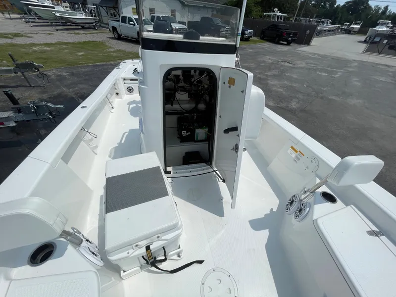 Slide: The Image of 2023 BlackJack 256 Bay boat interior with open console door and seating. - 21
