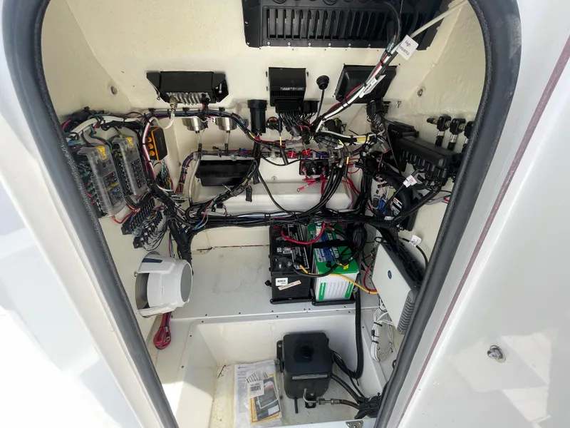 Slide: The Image of 2023 BlackJack 256 Bay boat electrical compartment with wiring and components. - 22