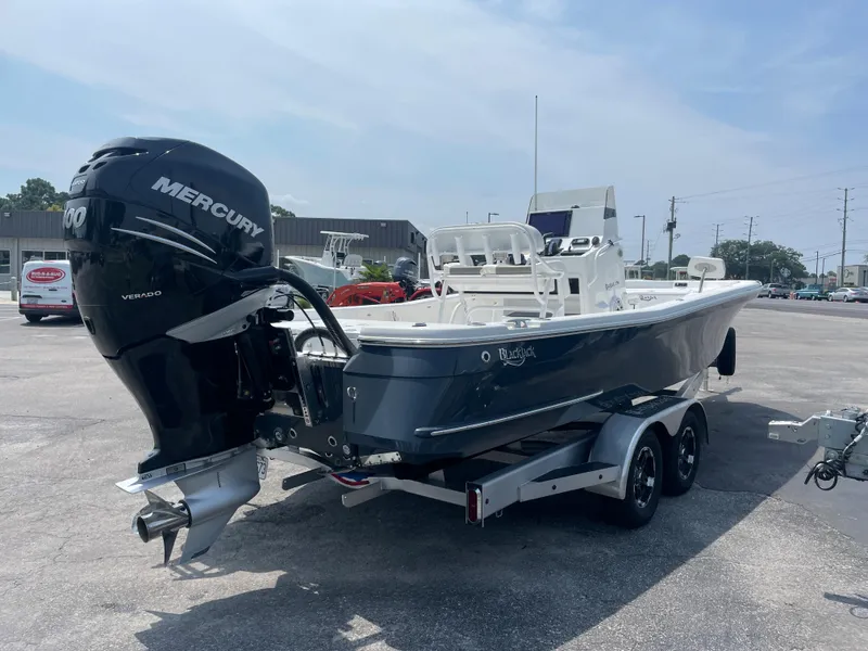 Slide: The Image of 2023 BlackJack 256 Bay boat with Mercury engine on trailer. - 5