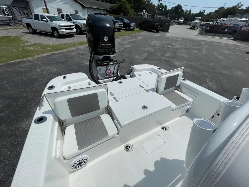 Slide: The Image of 2023 BlackJack 256 Bay boat with seating and outboard motor in a parking lot. - 9
