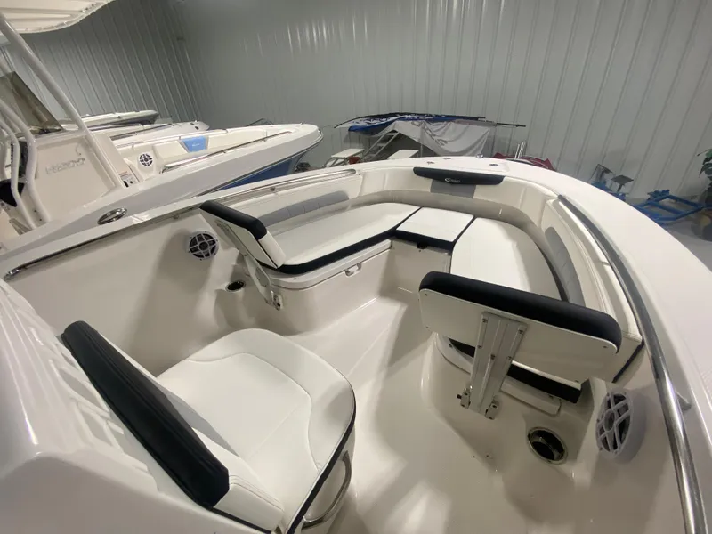 Slide: The Image of 2024 Robalo R202 Explorer boat interior with white and black seating. - 13
