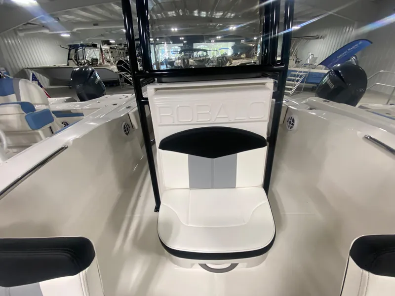 Slide: The Image of 2024 Robalo R202 Explorer boat interior with white and black seating. - 14