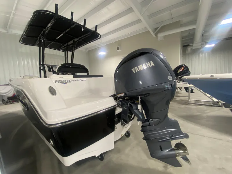 Slide: The Image of 2024 Robalo R202 Explorer boat with Yamaha outboard motor in showroom. - 4