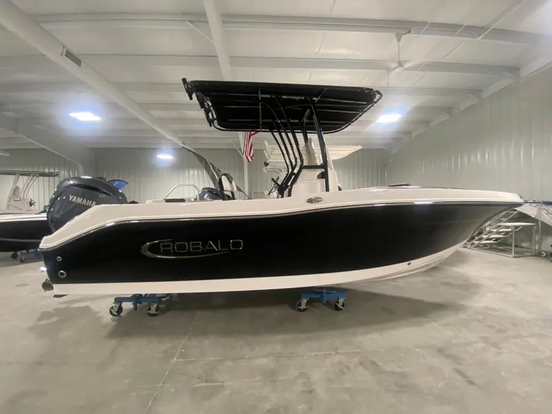 Slide: The Image of 2024 Robalo R202 Explorer boat in indoor showroom. - 0