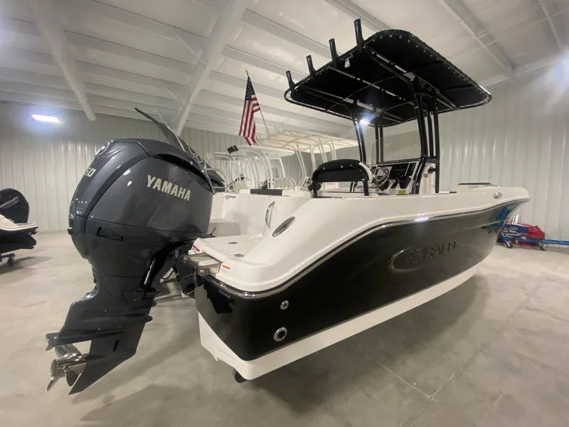 Slide: The Image of 2024 Robalo R202 Explorer boat with Yamaha engine in a showroom. - 1