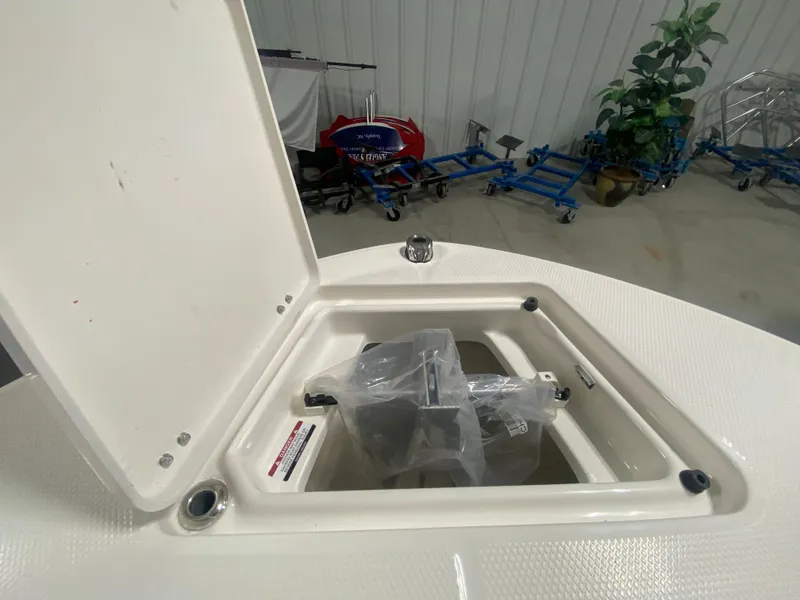 Slide: The Image of 2024 Robalo R202 Explorer storage compartment with open hatch. - 19