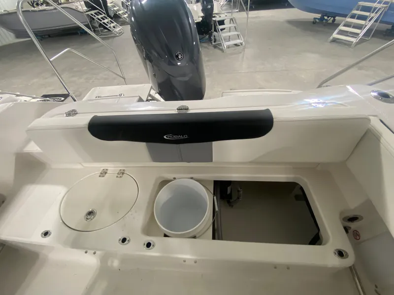 Slide: The Image of 2024 Robalo R202 Explorer boat interior with storage compartments and engine. - 7