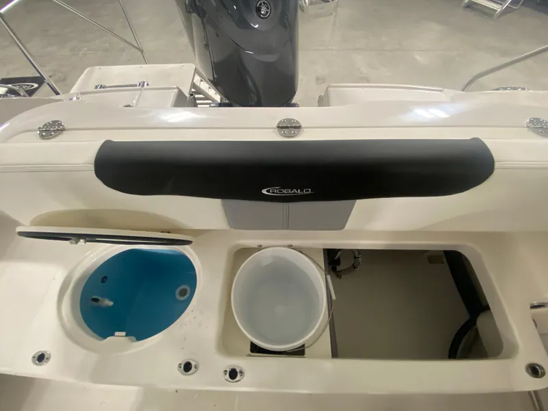 Slide: The Image of 2024 Robalo R202 Explorer boat interior with storage compartments and engine. - 8
