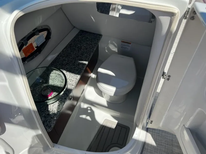 Slide: The Image of 2023 Crownline 260 SS boat interior bathroom with toilet and sink. - 5