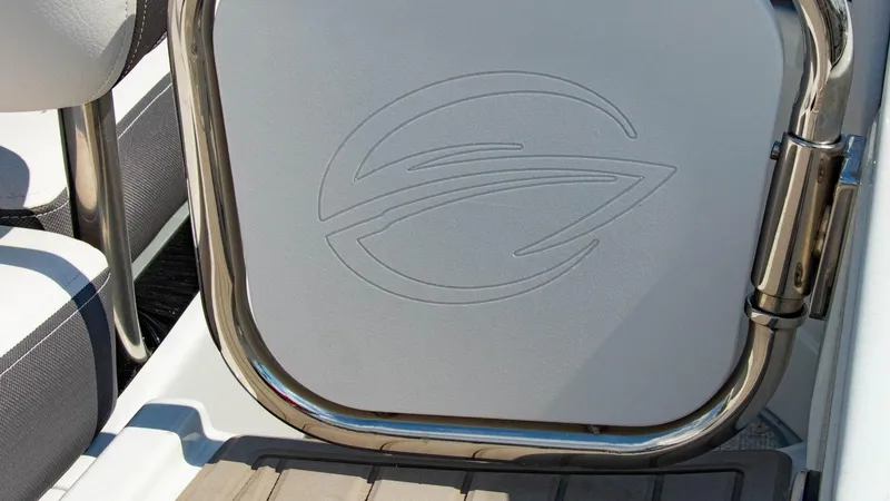 Slide: The Image of 2023 Crownline 290 XSS boat interior detail with logo and stainless steel hinge. - 22